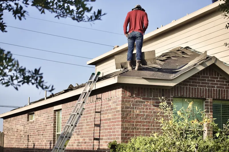 Professional roofer working on a residential roof in Lafayetteville